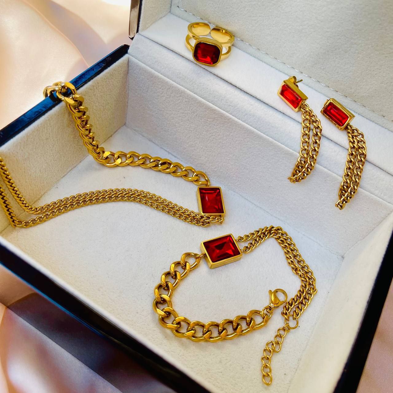 A set of red necklaces, earrings, rings and steel rings